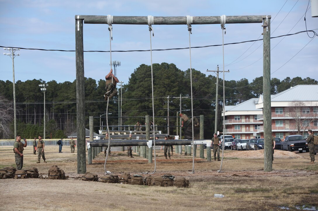 Marines with Marine Wing Communications Squadron 28 maneuver through the obstacle course at Marine Corps Air Station Cherry Point, N.C., Feb. 17, 2016. More than 85 noncommissioned officers with the squadron participated in the physical training exercise “Chaos,” which tested their warfighting abilities: strength, communication and dependability. During the training the Marines were put into fire teams where they had to navigate the obstacle course, trek through the combat pool and hike one-mile with a simulated casualty and assault load. The purpose of the event was to build on unit cohesion, esprit de corps and mental and physical resiliency. 