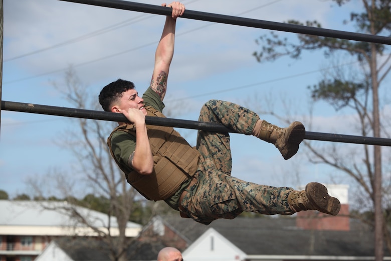 Sergeant Nathaniel Narvaez pulls himself up on a bar while maneuvering the obstacle course at Marine Corps Air Station Cherry Point, N.C., Feb. 17, 2016. More than 85 noncommissioned officers with Marine Wing Communications Squadron 28 participated in the physical training exercise “Chaos,” which tested their warfighting abilities: strength, communication and dependability. During the training the Marines were put into fire teams where they had to navigate the obstacle course, trek through the combat pool and hike one-mile with a simulated casualty and assault load. The purpose of the event was to build on unit cohesion, esprit de corps and mental and physical resiliency. Narvaez is a field radio operator with MWCS-28. 