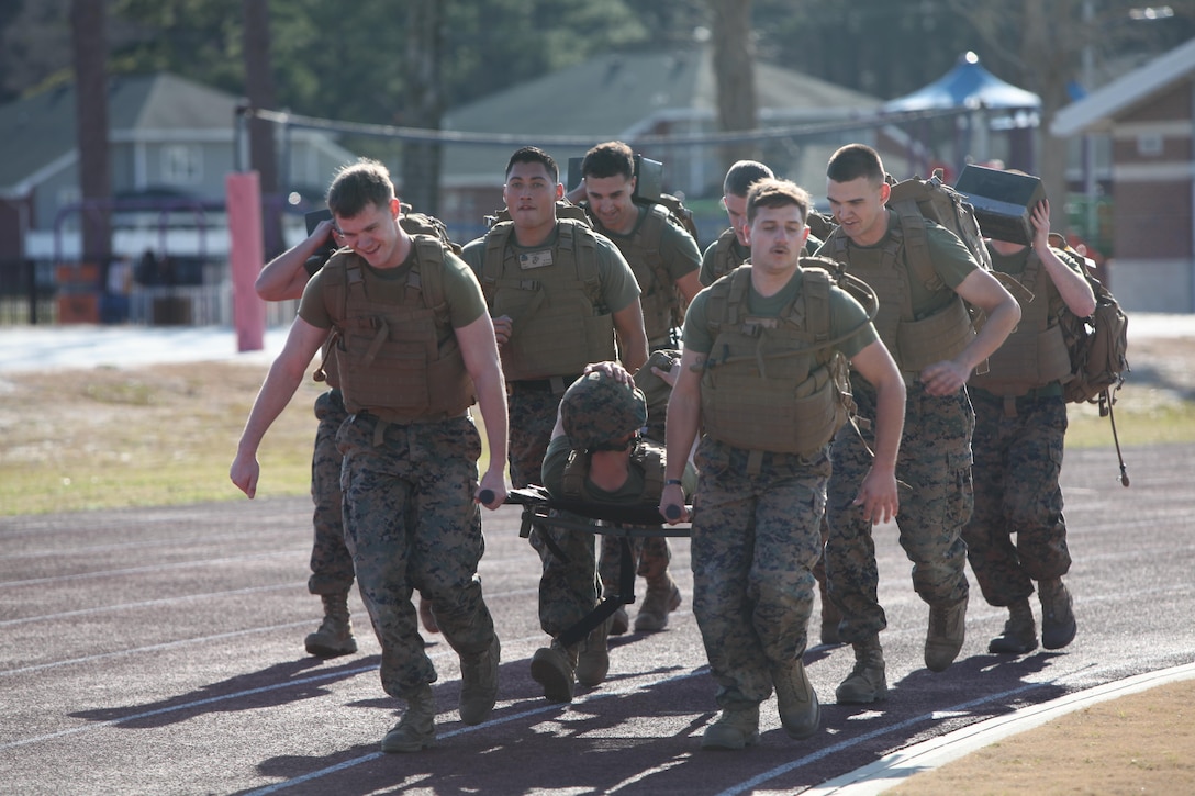 Noncommissioned officers carry a simulated casualty and assault load during a hike at Marine Corps Air Station Cherry Point, N.C., Feb. 17, 2016. More than 85 noncommissioned officers with Marine Wing Communications Squadron 28 participated in the physical training exercise “Chaos,” which tested their warfighting abilities: strength, communication and dependability. During the training the Marines were put into fire teams where they had to navigate the obstacle course, trek through the combat pool and hike one-mile with a simulated casualty and assault load. The purpose of the event was to build on unit cohesion, esprit de corps and mental and physical resiliency. 