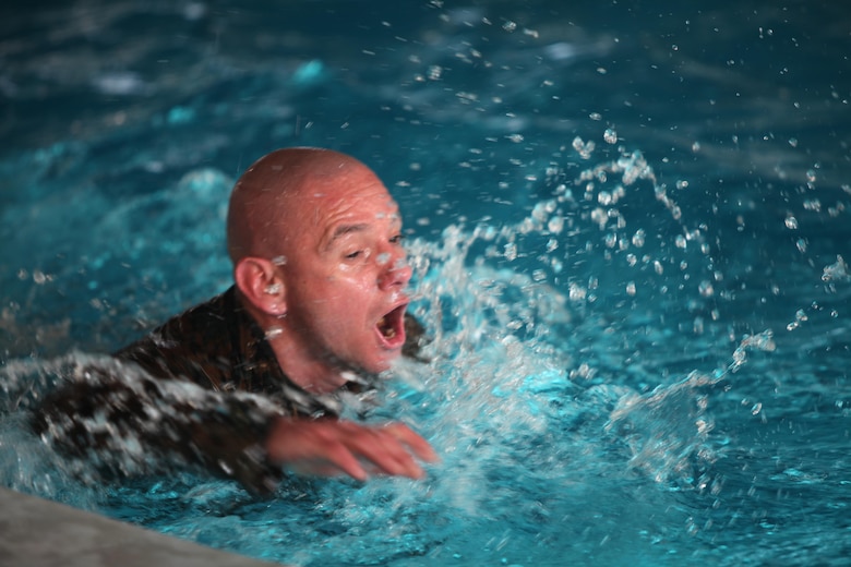 Sergeant Maj. Rogelio Deleon swims in a combat pool at Marine Corps Air Station Cherry Point, N.C., Feb. 17, 2016. More than 85 noncommissioned officers with Marine Wing Communications Squadron 28 participated in the physical training exercise “Chaos,” which tested their warfighting abilities: strength, communication and dependability. During the training the Marines were put into fire teams where they had to navigate the obstacle course, trek through the combat pool and hike one-mile with a simulated casualty and assault load. The purpose of the event was to build on unit cohesion, esprit de corps and mental and physical resiliency. Deleon is the sergeant major of MWCS-28.