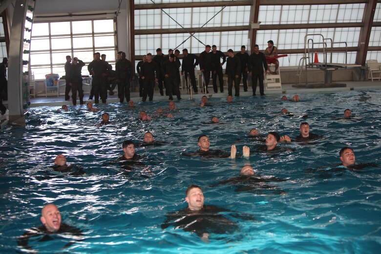 Marines with Marine Wing Communications Squadron 28 swim across the combat pool at Marine Corps Air Station Cherry Point, N.C., Feb. 17, 2016. More than 85 noncommissioned officers with the squadron participated in the physical training exercise “Chaos,” which tested their warfighting abilities: strength, communication and dependability. During the training the Marines were put into fire teams where they had to navigate the obstacle course, trek through the combat pool and hike one-mile with a simulated casualty and assault load. The purpose of the event was to build on unit cohesion, esprit de corps and mental and physical resiliency.