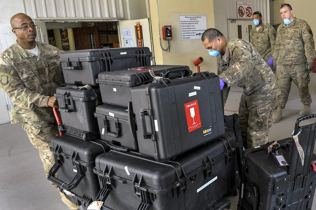 Airmen transfer and secure the Extracorporeal Membrane Oxygenation team’s equipment during a patient transfer at the Craig Joint-Theater Hospital at Bagram Airfield, Afghanistan, Feb. 18, 2016. Air Force photo by Tech. Sgt. Nicholas Rau