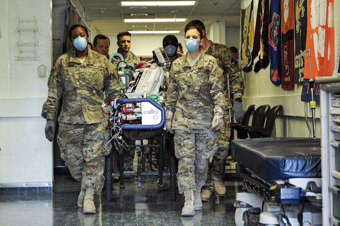 Airmen work with members of the Extracorporeal Membrane Oxygenation team to transport a NATO service member at the Craig Joint-Theater Hospital on Bagram Airfield, Afghanistan, Feb. 18, 2016. Air Force photo by Tech. Sgt. Nicholas Rau