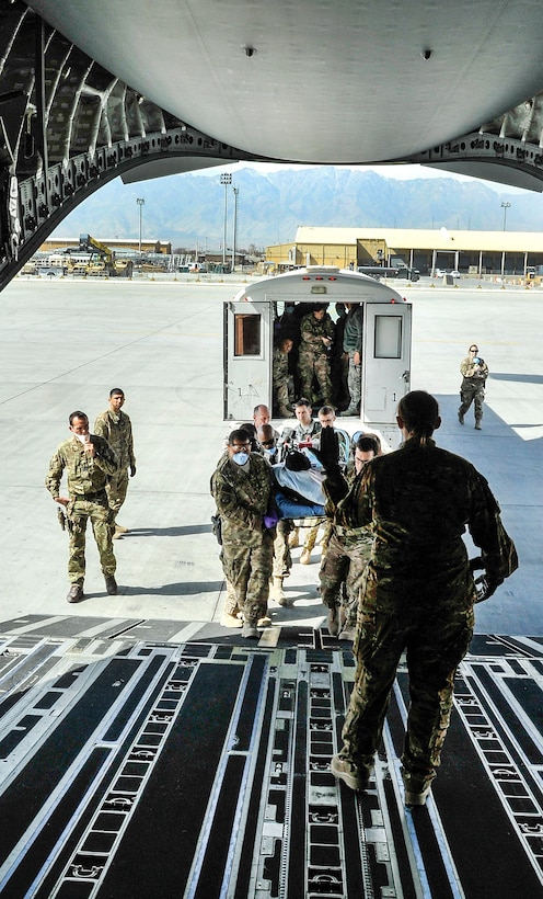Airmen load a NATO service member onto an aeromedical evacuation transport on Bagram Airfield, Afghanistan, Feb. 18, 2016. Air Force photo by Tech. Sgt. Nicholas Rau