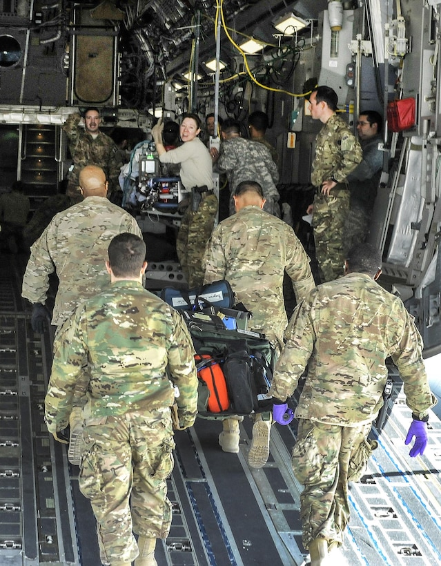 Airmen load equipment used to save the life of a NATO service member onto an aeromedical evacuation transport on Bagram Airfield, Afghanistan, Feb. 18, 2016. Air Force photo by Tech. Sgt. Nicholas Rau