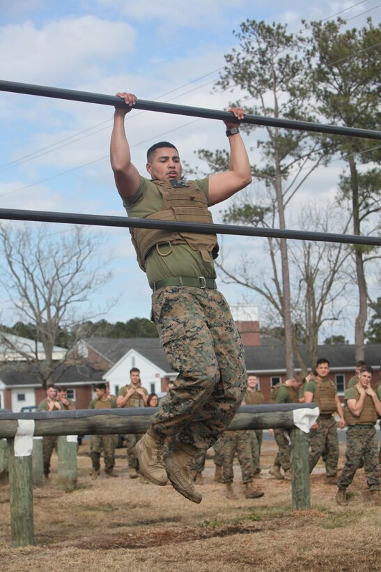 Corporal Erix Quinteros pulls himself up on a bar while maneuvering the obstacle course at Marine Corps Air Station Cherry Point, N.C., Feb. 17, 2016. More than 85 noncommissioned officers with Marine Wing Communications Squadron 28 participated in the physical training exercise “Chaos,” which tested their warfighting abilities: strength, communication and dependability. During the training the Marines were put into fire teams where they had to navigate the obstacle course, trek through the combat pool and hike one-mile with a simulated casualty and assault load. The purpose of the event was to build on unit cohesion, esprit de corps and mental and physical resiliency. Quinteros is an automotive maintenance technician with MWCS-28. 