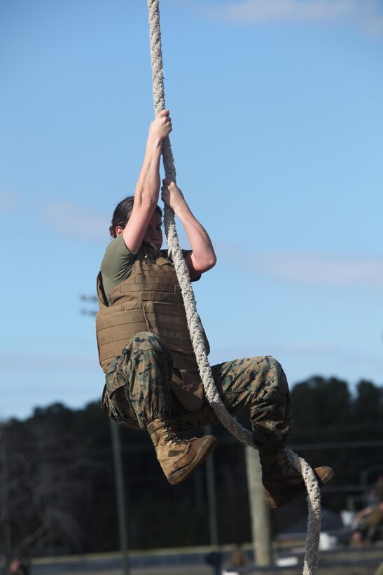 Sergeant Brittany Page climbs a rope while maneuvering the obstacle course at Marine Corps Air Station Cherry Point, N.C., Feb. 17, 2016. More than 85 noncommissioned officers with Marine Wing Communications Squadron 28 participated in the physical training exercise “Chaos,” which tested their warfighting abilities: strength, communication and dependability. During the training the Marines were put into fire teams where they had to navigate the obstacle course, trek through the combat pool and hike one-mile with a simulated casualty and assault load. The purpose of the event was to build on unit cohesion, esprit de corps and mental and physical resiliency. Page is a Tropospheric Scatter Radio Multi-channel Equipment Operator with MWCS-28. 