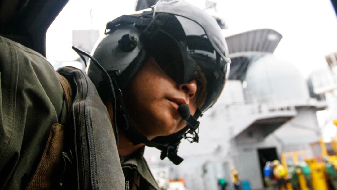 Sgt. Nicholas Attikai leans out of an MV-22B Osprey belonging to Marine Medium Tiltrotor Squadron 265, 31st Marine Expeditionary Unit, to ensure the aircraft is clear to take off from the deck of the USS Bonhomme Richard, Feb. 12, 2016. Marines and sailors with the 31st MEU flew from the BHR to the Ie Shima Training Facility to conduct a vertical assault as part of amphibious integration training with the ships of the Bonhomme Richard Amphibious Ready Group. Attikai, a native of Tonalea, Arizona, is an Osprey crew chief with VMM-265, 31st MEU. 