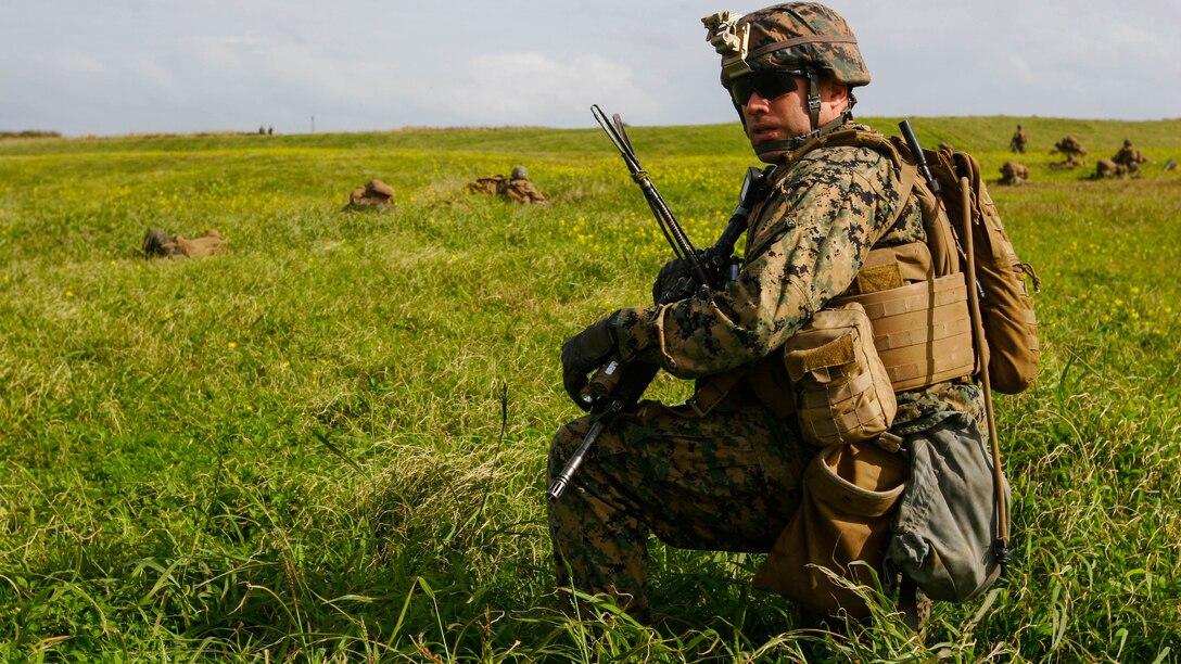 Capt. Christopher Caldwell, the company commander with Charlie Company, Battalion Landing Team 1st Battalion, 5th Marines, 31st Marine Expeditionary Unit, scans his Marines' positions as they prepare for an assault on the airfield at Ie Shima Training Facility, Okinawa, Japan, Feb. 12, 2016. Marines and sailors with the 31st MEU flew from the USS Bonhomme Richard to Ie Shima for a vertical assault as part of amphibious integration training with the Navy ships of the Bonhomme Richard Amphibious Ready Group. The 31st MEU is currently deployed to the Asia-Pacific region. Caldwell is a native of Virginia Beach, Virginia. 