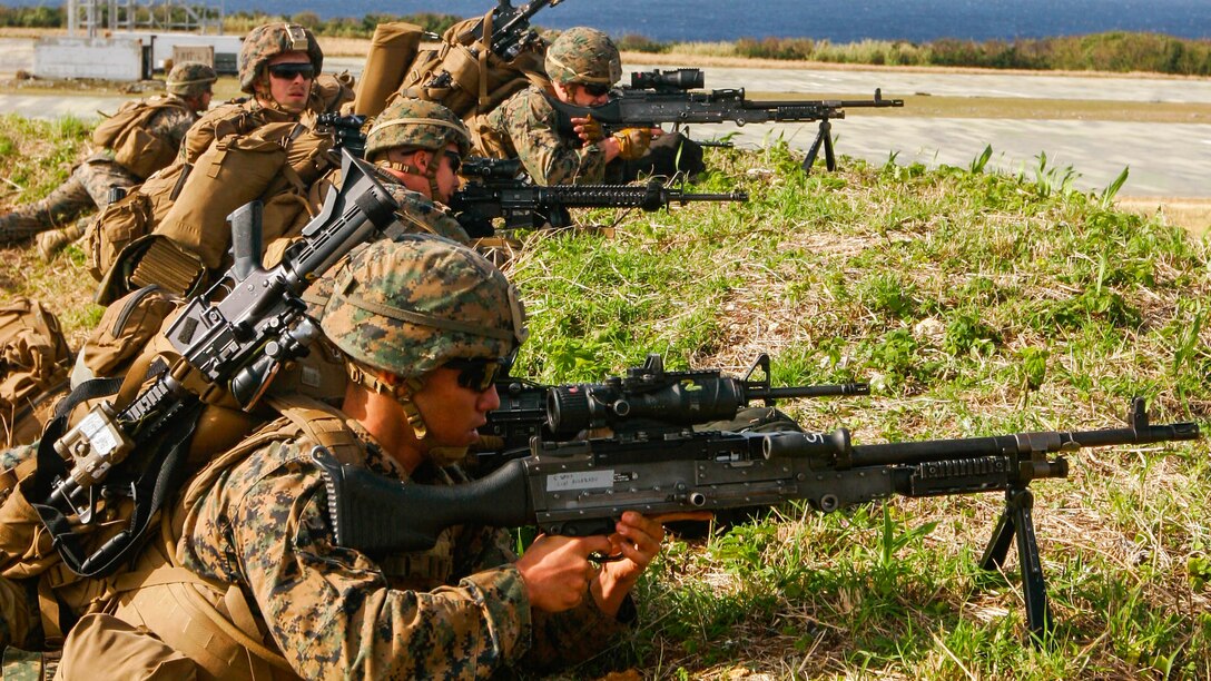 Machine gunners with Charlie Company, Battalion Landing Team 1st Battalion, 5th Marines, 31st Marine Expeditionary  Unit, lay down simulated cover fire for Marines assaulting the airfield at Ie Shima Training Facility, Okinawa, Japan, Feb. 12, 2016. Marines and sailors with the 31st MEU flew from the USS Bonhomme Richard to Ie Shima for a vertical assault as part of amphibious integration training with the Navy ships of the Bonhomme Richard Amphibious Ready Group. The 31st MEU is currently deployed to the Asia-Pacific region. 