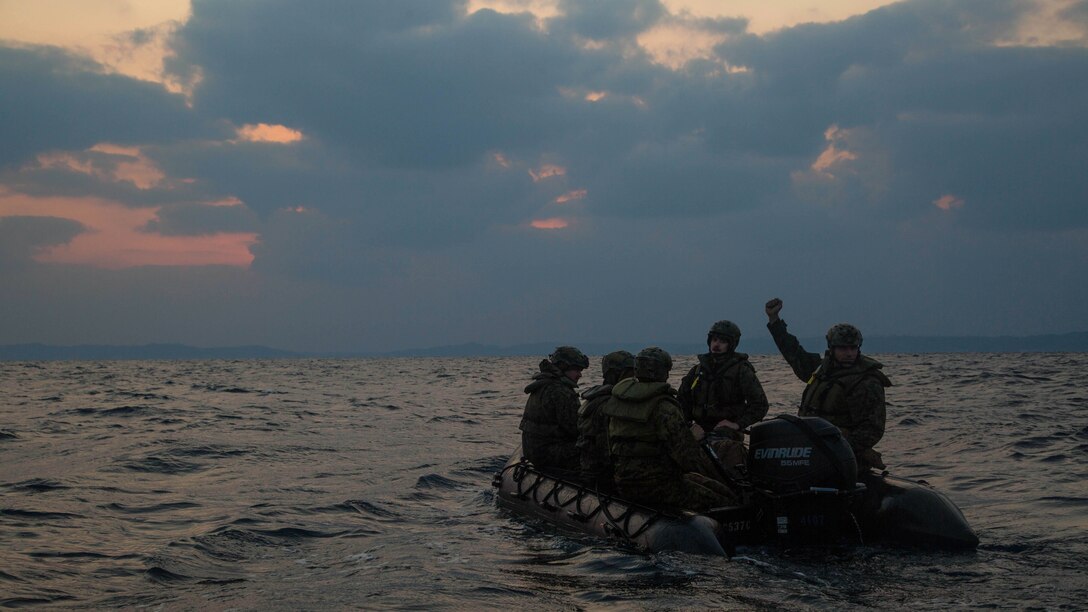 Marines with Bravo Company, Battalion Landing Team 1st Battalion, 5th Marines, 31st Marine Expeditionary Unit, use hand signals to communicate with Marines in other Combat Rubber Raiding Craft after launching from the USS Germantown, Feb. 16 , 2016. The Marines conducted a boat raid as part of the 31st MEU's amphibious integration training with the Navy ships of the Bonhomme Richard Amphibious Ready Group. The Marines and sailors of the 31st MEU are currently deployed to the Asia-Pacific region. 