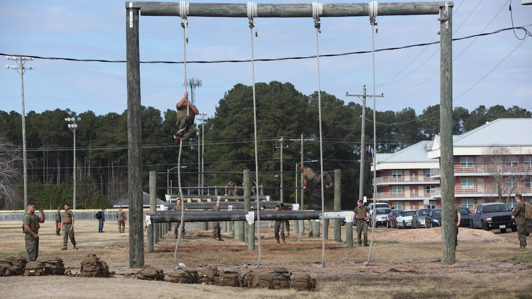 Marines with Marine Wing Communications Squadron 28 maneuver through the obstacle course at Marine Corps Air Station Cherry Point, N.C., Feb. 17, 2016. More than 85 noncommissioned officers with the squadron participated in the physical training exercise “Chaos,” which tested their warfighting abilities: strength, communication and dependability. During the training the Marines were put into fire teams where they had to navigate the obstacle course, trek through the combat pool and hike one-mile with a simulated casualty and assault load. The purpose of the event was to build on unit cohesion, esprit de corps and mental and physical resiliency.