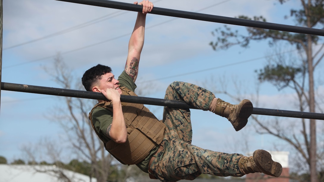 Sergeant Nathaniel Narvaez pulls himself up on a bar while maneuvering the obstacle course at Marine Corps Air Station Cherry Point, N.C., Feb. 17, 2016. More than 85 noncommissioned officers with Marine Wing Communications Squadron 28 participated in the physical training exercise “Chaos,” which tested their warfighting abilities: strength, communication and dependability. During the training the Marines were put into fire teams where they had to navigate the obstacle course, trek through the combat pool and hike one-mile with a simulated casualty and assault load. The purpose of the event was to build on unit cohesion, esprit de corps and mental and physical resiliency. Narvaez is a field radio operator with MWCS-28.