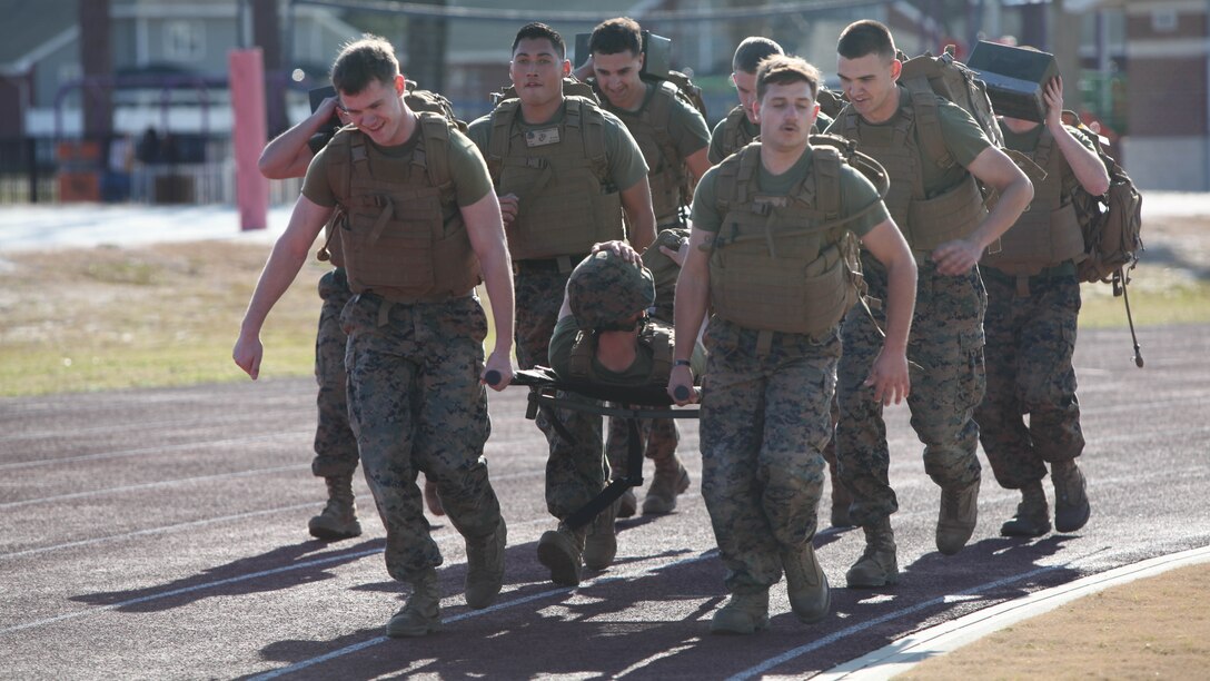 Noncommissioned officers carry a simulated casualty and assault load during a hike at Marine Corps Air Station Cherry Point, N.C., Feb. 17, 2016. More than 85 noncommissioned officers with Marine Wing Communications Squadron 28 participated in the physical training exercise “Chaos,” which tested their warfighting abilities: strength, communication and dependability. During the training the Marines were put into fire teams where they had to navigate the obstacle course, trek through the combat pool and hike one-mile with a simulated casualty and assault load. The purpose of the event was to build on unit cohesion, esprit de corps and mental and physical resiliency.