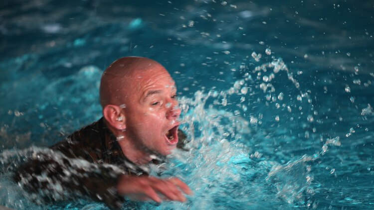 Sergeant Maj. Rogelio Deleon swims in a combat pool at Marine Corps Air Station Cherry Point, N.C., Feb. 17, 2016. More than 85 noncommissioned officers with Marine Wing Communications Squadron 28 participated in the physical training exercise “Chaos,” which tested their warfighting abilities: strength, communication and dependability. During the training the Marines were put into fire teams where they had to navigate the obstacle course, trek through the combat pool and hike one-mile with a simulated casualty and assault load. The purpose of the event was to build on unit cohesion, esprit de corps and mental and physical resiliency. Deleon is the sergeant major of MWCS-28.