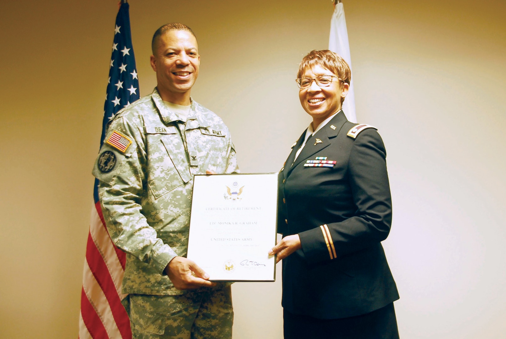 District of Columbia Army National Guard (DCNG), Lt. Col. Monika R. Graham, medical detachment commander is presented a certificate of retirement by the DCNG Chief of Staff, Col. Aaron R. Dean during her retirement ceremony, DC Armory, Washington, Feb. 21. Graham received several awards for 27 years of distinguished service and countless achievements through her career to include the Legion of Merit and the DCNG Meritorious Service Medal.
