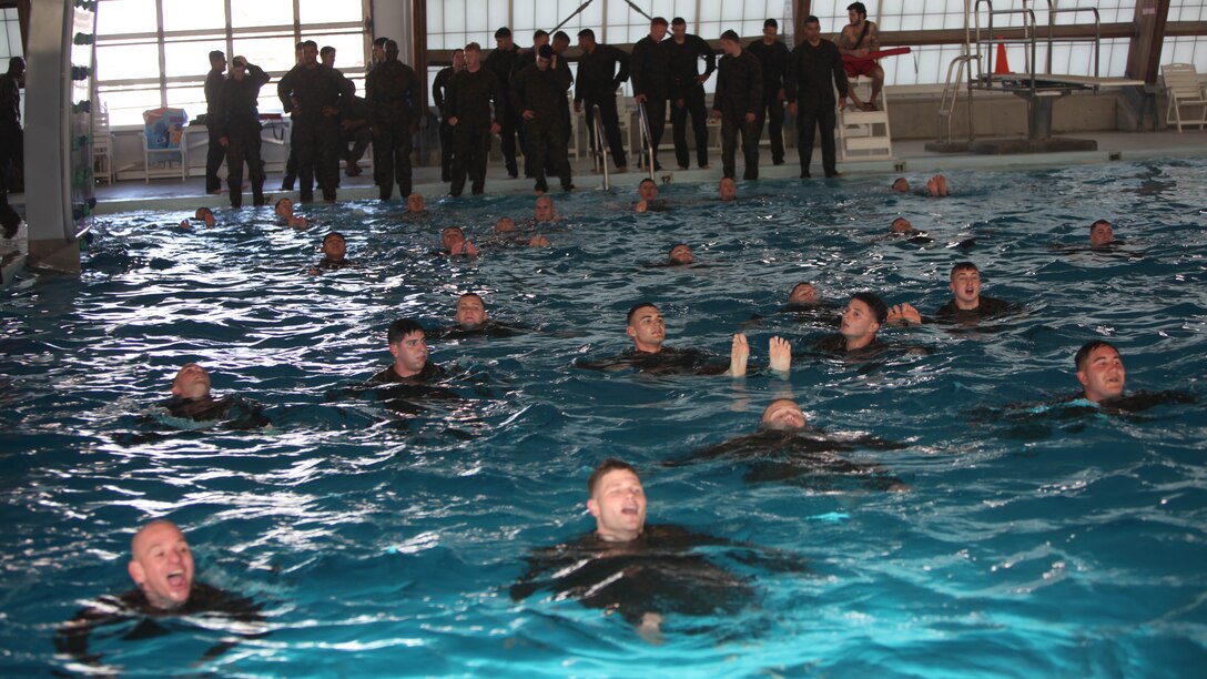 Marines with Marine Wing Communications Squadron 28 swim across the combat pool at Marine Corps Air Station Cherry Point, N.C., Feb. 17, 2016. More than 85 noncommissioned officers with the squadron participated in the physical training exercise “Chaos,” which tested their warfighting abilities: strength, communication and dependability. During the training the Marines were put into fire teams where they had to navigate the obstacle course, trek through the combat pool and hike one-mile with a simulated casualty and assault load. The purpose of the event was to build on unit cohesion, esprit de corps and mental and physical resiliency.