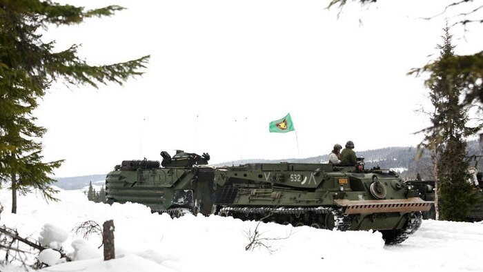 A Norwegian recovery vehicle hooks up to a U.S. Marine Corps Amphibious Assault Vehicle prior to the start of a live-fire range in Rena, Norway, as part of their pre-exercise training Feb. 17, 2016. The Marines and Norwegian Army are working together as part of Exercise Cold Response, a joint NATO and allied country exercise comprised of 12 countries and approximately 16,000 troops. The U.S. European Command appreciates the opportunity for taking part in such a large multinational exercise at the invitation of our Norwegian Allies; and we are especially thankful for the chance to put our skills to the test in unique cold weather conditions. 