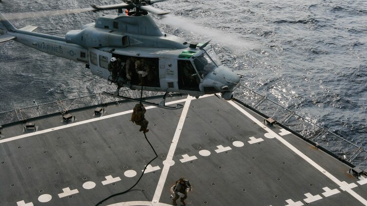 Reconnaissance Marines with Maritime Raid Force, 31st Marine Expeditionary Unit, fast-rope to the deck of the USNS Rappahannock from a UH-1Y Huey belonging to Marine Medium Tiltrotor Squadron, 31st MEU, during a visit, board, search and seizure training exercise Feb. 17, 2016. The VBSS was conducted as part of the MEU's amphibious integration training with the Navy ships of the Bonhomme Richard Amphibious Ready Group. The Marines and sailors of the 31st MEU are currently on their spring deployment to the Asia-Pacific region. 