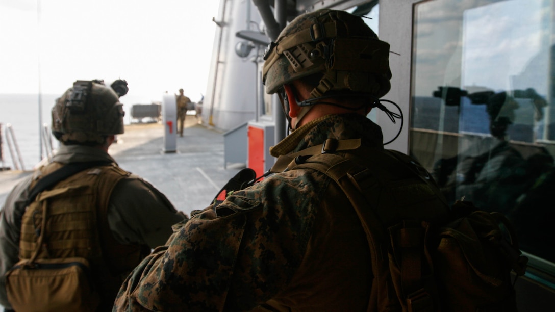 Two reconnaissance Marines with Maritime Raid Force, 31st Marine Expeditionary Unit, work to secure the upper decks of the USNS Rappahannock during a visit, board, search and seizure training exercise Feb. 17, 2016. The VBSS was conducted as part of the MEU's amphibious integration training with the Navy ships of the Bonhomme Richard Amphibious Ready Group. The Marines and sailors of the 31st MEU are currently on their spring deployment to the Asia-Pacific region.