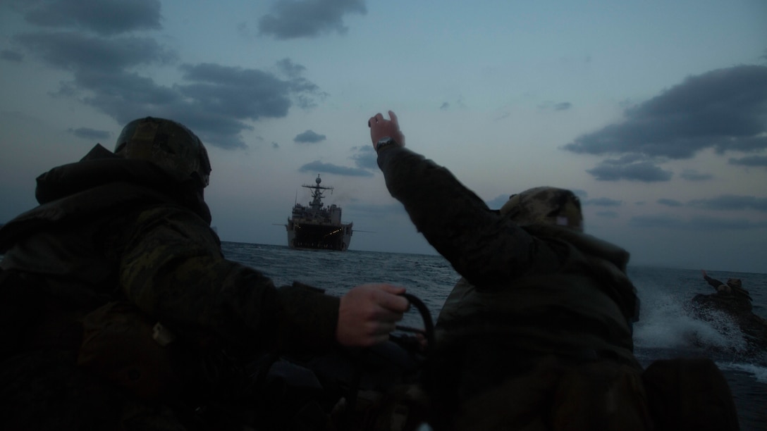 Marines with Bravo Company, Battalion Landing Team 1st Battalion, 5th Marines, 31st Marine Expeditionary Unit, send hand signals as they head back to the USS Germantown in Combat Rubber Raiding Craft, Feb. 17 , 2016, after conducting a successful boat raid the night before. The Marines conducted the boat raid as part of the 31st MEU's amphibious integration training with the Navy ships of the Bonhomme Richard Amphibious Ready Group. The Marines and sailors of the 31st MEU are currently deployed to the Asia-Pacific region.