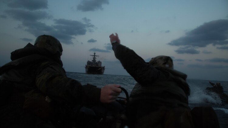 Marines with Bravo Company, Battalion Landing Team 1st Battalion, 5th Marines, 31st Marine Expeditionary Unit, send hand signals as they head back to the USS Germantown in Combat Rubber Raiding Craft, Feb. 17 , 2016, after conducting a successful boat raid the night before. The Marines conducted the boat raid as part of the 31st MEU's amphibious integration training with the Navy ships of the Bonhomme Richard Amphibious Ready Group. The Marines and sailors of the 31st MEU are currently deployed to the Asia-Pacific region.