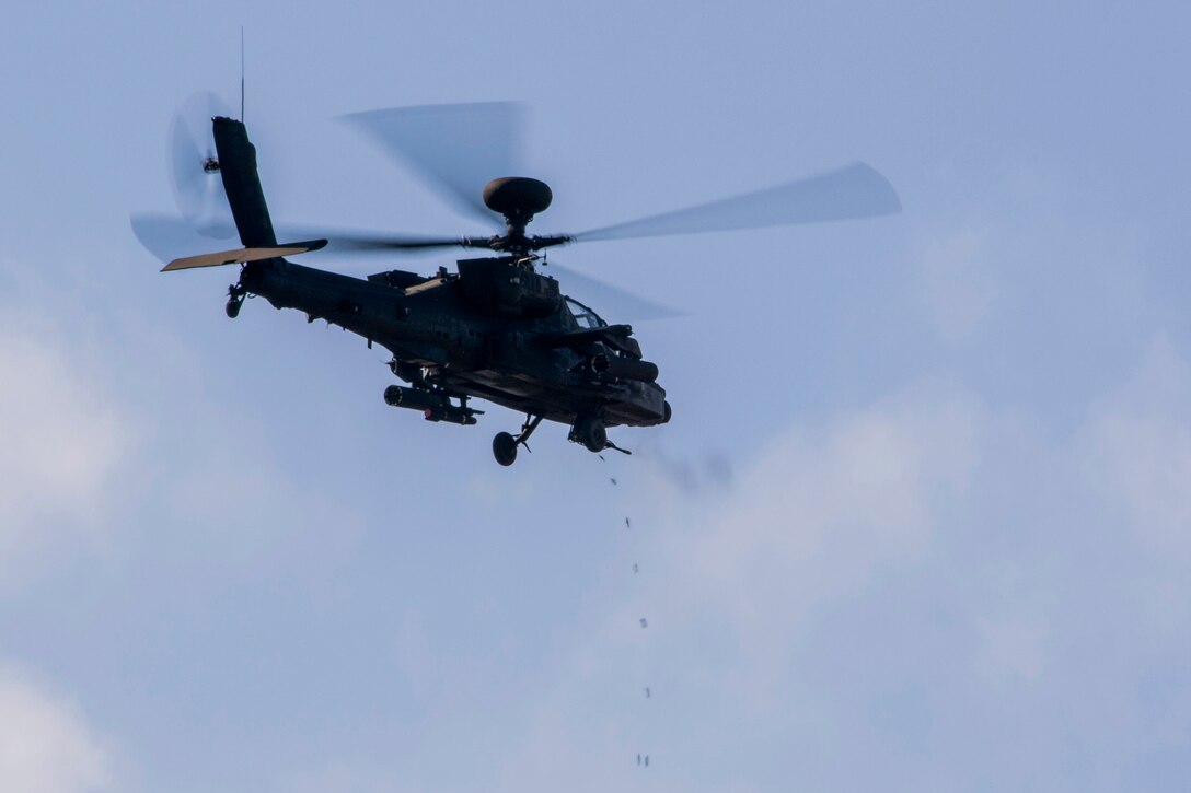 Empty casings fall from an AH-64 Apache helicopter during an aerial gunnery exercise on Fort A.P. Hill, Va., Feb. 17, 2016. Army photo by Staff Sgt. Christopher Freeman