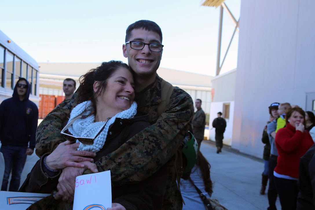 A Marine is reunited with his family during a homecoming ceremony at Marine Corps Air Station Cherry Point, N.C., Feb. 11, 2016. Marines and Sailors with Marine Tactical Electronic Warfare Squadron 3 returned to the air station after a six-month deployment in support of the United States Pacific Command combatant commander, Marine Aircraft Group 12, 1st Marine Aircraft Wing with EA-6B expeditionary electronic warfare capabilities. (U.S. Marine Corps photo by Cpl. N.W. Huertas/Released)