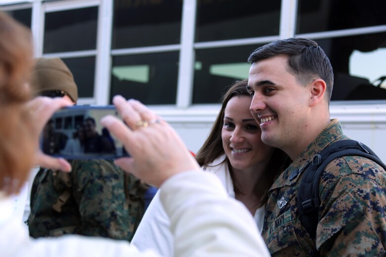 Petty officer 3rd class John Price poses with his wife Sarah during a homecoming ceremony at Marine Corps Air Station Cherry Point, N.C., Feb. 11, 2016. Marines and Sailors with Marine Tactical Electronic Warfare Squadron 3 returned to the air station after a six-month deployment in support of the United States Pacific Command combatant commander, Marine Aircraft Group 12, 1st Marine Aircraft Wing with EA-6B expeditionary electronic warfare capabilities. Price is a corpsman with the squadron. (U.S. Marine Corps photo by Cpl. N.W. Huertas/Released)