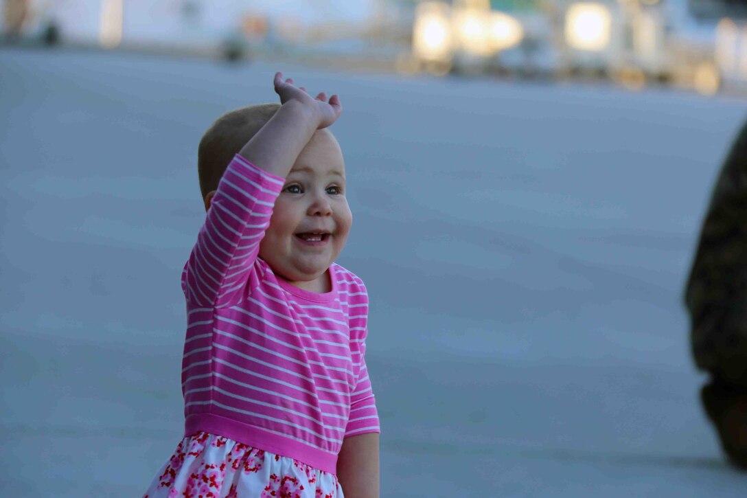 Adelaide , age 1, waves at Landing crew during a homecoming ceremony at Marine Corps Air Station Cherry Point, N.C., Feb. 16, 2016. Marines and Sailors with Marine Tactical Electronic Warfare Squadron 3 returned to the air station after a six-month deployment in support of the United States Pacific Command combatant commander, Marine Aircraft Group 12, 1st Marine Aircraft Wing with EA-6B expeditionary electronic warfare capabilities. (U.S. Marine Corps photo by Cpl. N.W. Huertas/Released)
