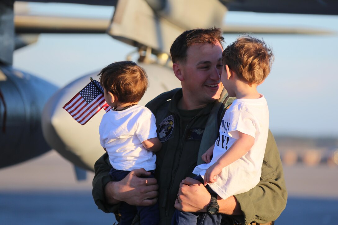 Captain Adam Chase embraces his sons during a homecoming ceremony at Marine Corps Air Station Cherry Point, N.C., Feb. 16, 2016. Marines and Sailors with Marine Tactical Electronic Warfare Squadron 3 returned to the air station after a six-month deployment in support of the United States Pacific Command combatant commander, Marine Aircraft Group 12, 1st Marine Aircraft Wing with EA-6B expeditionary electronic warfare capabilities. Chase is an embark action officer with the squadron. (U.S. Marine Corps photo by Cpl. N.W. Huertas/Released)