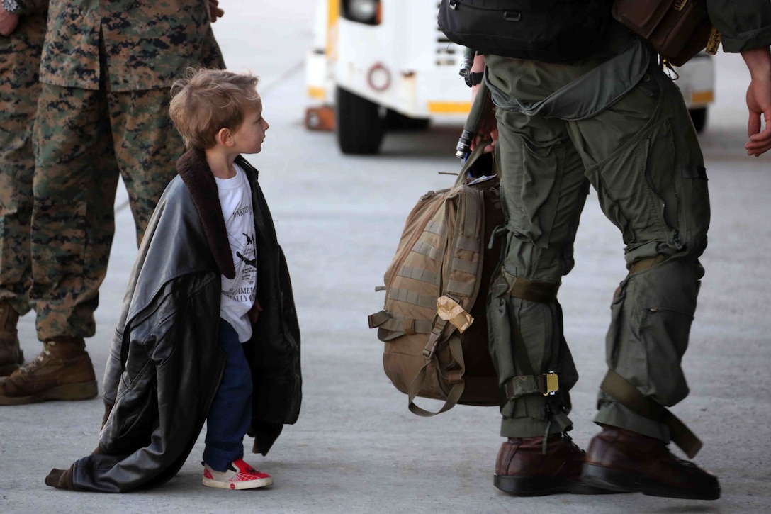 Logan, age 3, follows his father during a homecoming ceremony at Marine Corps Air Station Cherry Point, N.C., Feb. 16, 2016. Marines and Sailors with Marine Tactical Electronic Warfare Squadron 3 returned to the air station after a six-month deployment in support of the United States Pacific Command combatant commander, Marine Aircraft Group 12, 1st Marine Aircraft Wing with EA-6B expeditionary electronic warfare capabilities. (U.S. Marine Corps photo by Cpl. N.W. Huertas/Released)