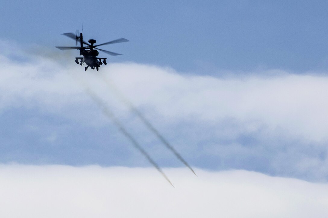 An AH-64 Apache helicopter fires its rockets during an aerial gunnery exercise on Fort A.P. Hill, Va., Feb. 17, 2016. The exercise allowed the pilots to remain proficient on aerial gunnery qualification tables. Army photo by Staff Sgt. Christopher Freeman