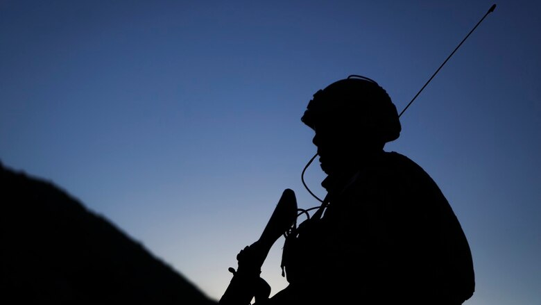 A field radio operator assigned to Western Army Infantry Regiment, Japan Ground Self Defense Force, observes the impact area, during a live-fire platoon level assault, during Exercise Iron Fist 2016, at Marine Corps Air Ground Combat Center Twentynine Palms, Feb. 9, 2016. Iron Fist is an annual, bi-lateral training exercise between the Japan Ground Self Defense Force and Marines to strengthen warfighting capabilities in ship to shore operations.
