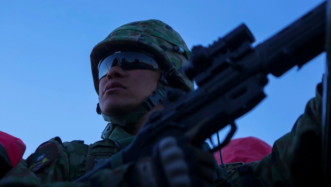 A rifleman assigned to Western Army Infantry Regiment, Japan Ground Self Defense Force, provides security from an amphibious assault vehicle, during a live-fire platoon level assault, during Exercise Iron Fist 2016 at Marine Corps Air Ground Combat Center Twentynine Palms, Feb. 9, 2016. Iron Fist is an annual bilateral training exercise between the Japan Ground Self Defense Force and Marines to strengthen warfighting capabilities in ship to shore operations.