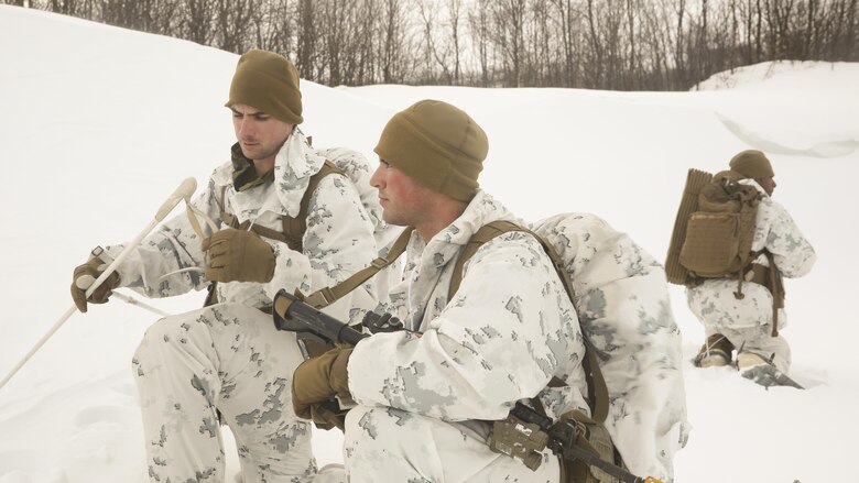 Cpl. Thomas Powers, a fire team leader with Black Sea Rotational Force, left, explains the next movement to Cpl. Greggory Williams, a machinegunner with BSRF, while conducting a routine patrol during the final exercise of cold-weather training aboard Porsangmoen, Norway, Feb. 16-20, 2016. Arctic training was conducted by U.K. Royal Marine Commando Mountain Leaders and hosted by the Norwegian military to improve the U.S. Marine Corps’ capability to support their NATO Allies in extreme environments. 