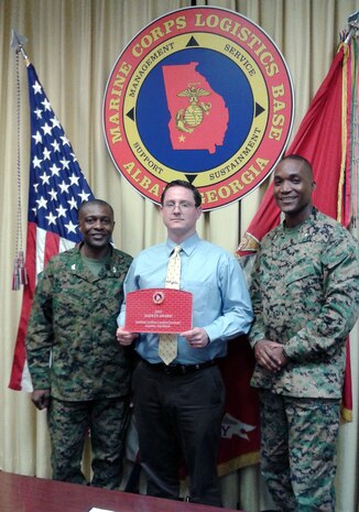 John Scholl (center), operations branch chief, Communications and Information System Division, Marine Corps Logistics Base Albany, accepts the 2015 Annual Safety Award from Col. James C. Carroll III (left), commanding officer, MCLB Albany, during the CO’s Quarterly Safety Council Meeting, Feb. 3. Lt. Col. Nathaniel Robinson (right), executive officer, MCLB Albany, assisted with the presentation.
