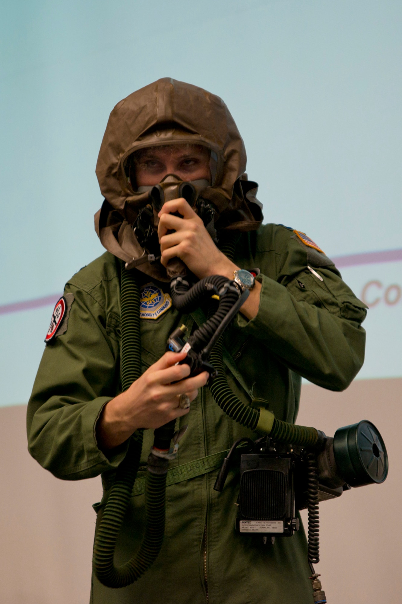 U.S. Air Force Capt. Kyle Capko, a pilot assigned to the 50th Airlift Squadron, dons an aircrew chemical, biological, radiological, nuclear and high yield (CBRNE) warfare protection device during a C-130 mission immersion tour at Little Rock Air Force Base, Ark., Feb. 19, 2016. Roughly 30 Airmen from the 19th and 913th Force Support Squadrons spent the morning at the event, which was hosted by the 50th Airlift Squadron commander, Lt. Col. James C. O’Brien III. (U.S. Air Force photo by Master Sgt. Jeff Walston/Released)   