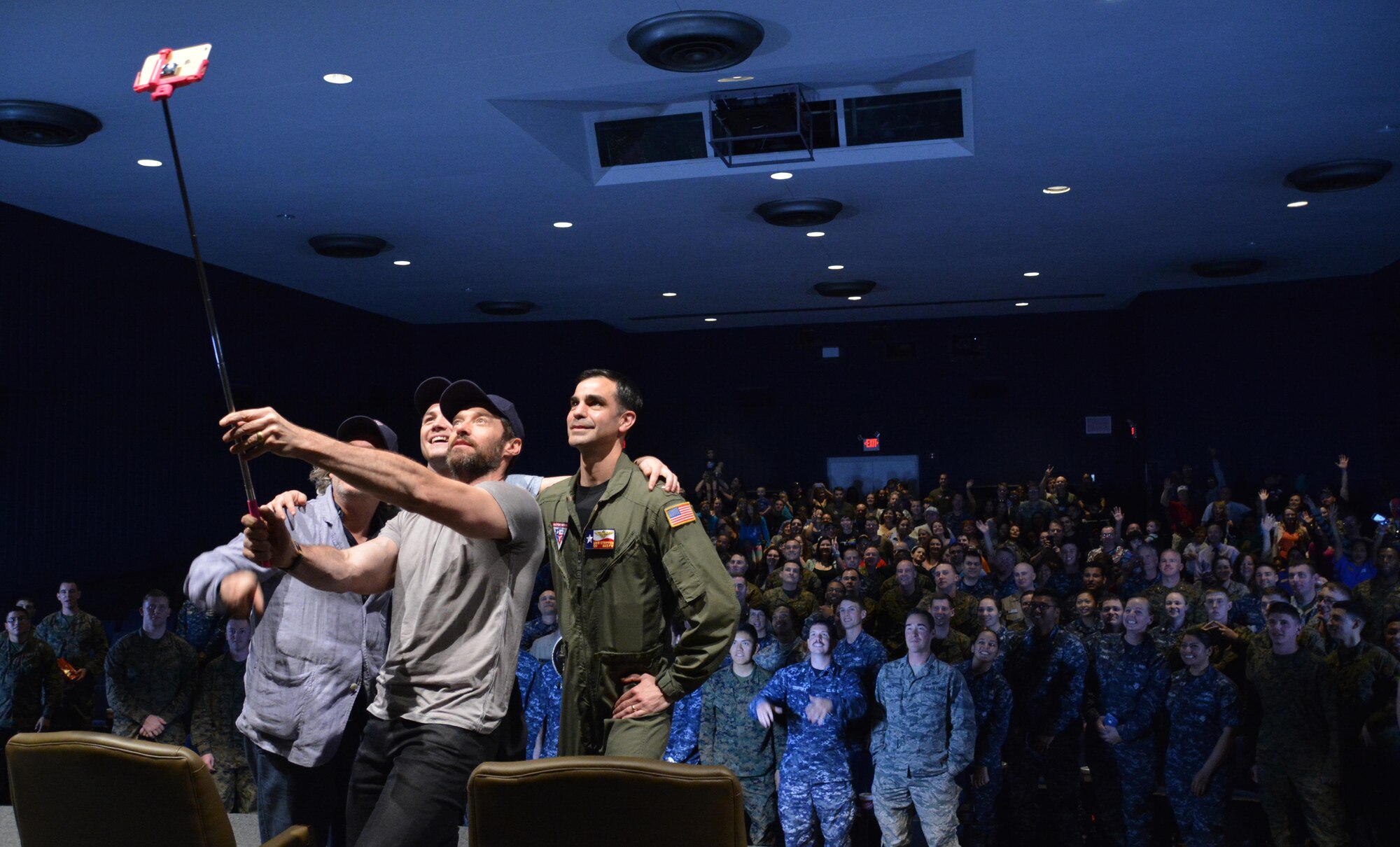 – “Eddie the Eagle” stars and director take a selfie here with Navy Capt. Michael Steffen, NAS Fort Worth JRB commander, and attendees of the movie sneak preview Feb. 19 at the base theater here. Movie stars, Hugh Jackman and Taron Egerton, and director Dexter Fletcher, spoke with service members and their families prior to the start of the movie. (U.S. Air Force photo by Staff Sgt. Samantha Mathison)