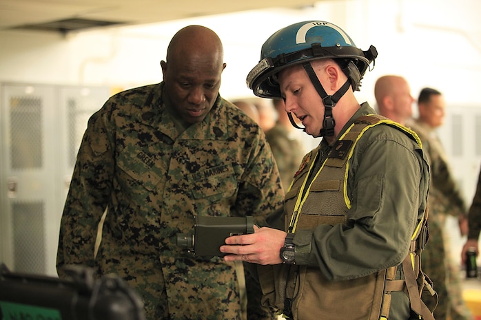 Morehead, Ky.-native Sgt. George R. Phillips, a SCAD squad leader with Identification and Detection Platoon, React Force Company, Chemical Biological Incident Response Force (CBIRF), describes the capabilities of the joint chemical agent detector (JCAD) to Sgt. Maj. Ronald L. Green, the 18th Sergeant Major of the Marine Corps, during an Initial Response Force static display in the battalion assembly room at CBIRF Headquarters, Naval Support Facility Indian Head, Feb. 18, 2016.
Green visited the Marines, sailors and civilians with CBIRF at Naval Support Facility Indian Head and Raymond M. Downey Responder Training Facility.
During Green’s visit, he received a CBIRF brief given by the CBIRF Commanding Officer, Col. Stephen E. Redifer, viewed a static display of an Initial Response Force set-up, talked to CBIRF personnel, toured the Downey Responder Training Facility and had lunch with CBIRF staff noncommissioned officers. 
When directed, CBIRF forward-deploys and/or responds with minimal warning to a chemical, biological, radiological, nuclear or high-yield explosive (CBRNE) threat or event in order to assist local, state, or federal agencies and the geographic combatant commanders in the conduct of CBRNE response or consequence management operations, providing capabilities for command and control; agent detection and identification; search, rescue, and decontamination; and emergency medical care for contaminated personnel. (Official USMC Photo by Sgt. Santiago G. Colon Jr./RELEASED)
