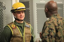 Cedar City, Utah- native Cpl. Sawyer L. Guerin, a non ambulatory decontamination Marine with Decontamination Platoon, React Force Company, Chemical Biological Incident Response Force (CBIRF), listens to Sgt. Maj. Ronald L. Green, the 18th Sergeant Major of the Marine Corps, during an Initial Response Force static display in the battalion assembly room at CBIRF Headquarters, Naval Support Facility Indian Head, Feb. 18, 2016.
Green visited the Marines, sailors and civilians with CBIRF at Naval Support Facility Indian Head and Raymond M. Downey Responder Training Facility.
During Green’s visit, he received a CBIRF brief given by the CBIRF Commanding Officer, Col. Stephen E. Redifer, viewed a static display of an Initial Response Force set-up, talked to CBIRF personnel, toured the Downey Responder Training Facility and had lunch with CBIRF staff noncommissioned officers. 
When directed, CBIRF forward-deploys and/or responds with minimal warning to a chemical, biological, radiological, nuclear or high-yield explosive (CBRNE) threat or event in order to assist local, state, or federal agencies and the geographic combatant commanders in the conduct of CBRNE response or consequence management operations, providing capabilities for command and control; agent detection and identification; search, rescue, and decontamination; and emergency medical care for contaminated personnel. (Official USMC Photo by Sgt. Santiago G. Colon Jr./RELEASED)
