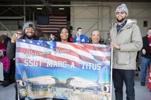 The Titus family holds a sign to welcome home Staff Sgt. Marc Titus, 434th Aircraft Maintenance Squadron crew chief, prior to his arrival at Grissom Air Reserve Base, Ind., Feb. 7, 2016. Grissom has a variety of resources to help families reunite after deployments. (U.S. Air Force photo/Tech. Sgt. Benjamin Mota) 
