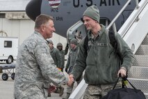 Col. Doug Schwartz, 434th Air Refueling Wing commander, greets Senior Airman David O’Donnell, 434th Maintenance Squadron aircraft electrician specialist, after returning to Grissom Air Reserve Base Feb. 7, 2016. In all, 68 Airmen returned from a 4-month deployment to Southwest Asia in support of Operation Inherent Resolve. (U.S. Air Force photo/Tech. Sgt. Benjamin Mota)