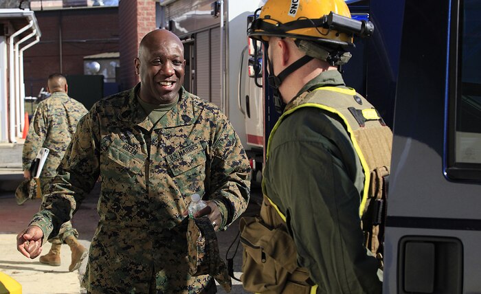 Sgt. Maj. Ronald L. Green, the 18th Sergeant Major of the Marine Corps, speaks to Greenwood, Indiana- native Cpl. Joshua N. Kelly, a radio operator with communications section, Chemical Biological Incident Response Force (CBIRF) during an Initial Response Force static display in the battalion assembly room at CBIRF Headquarters, Naval Support Facility Indian Head, Feb. 18, 2016.
Green visited the Marines, sailors and civilians with CBIRF at Naval Support Facility Indian Head and Raymond M. Downey Responder Training Facility.
During Green’s visit, he received a CBIRF brief given by the CBIRF Commanding Officer, Col. Stephen E. Redifer, viewed a static display of an Initial Response Force set-up, talked to CBIRF personnel, toured the Downey Responder Training Facility and had lunch with CBIRF staff noncommissioned officers. 
When directed, CBIRF forward-deploys and/or responds with minimal warning to a chemical, biological, radiological, nuclear or high-yield explosive (CBRNE) threat or event in order to assist local, state, or federal agencies and the geographic combatant commanders in the conduct of CBRNE response or consequence management operations, providing capabilities for command and control; agent detection and identification; search, rescue, and decontamination; and emergency medical care for contaminated personnel. (Official USMC Photo by Sgt. Santiago G. Colon Jr./RELEASED)
