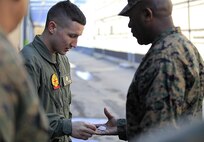 Manhattan, Kan.- native Lance Cpl. Gunnar I. Naughton, a team member with Identification Platoon, React Force Company, Chemical Biological Incident Response Force (CBIRF), receives a challenge coin from Sgt. Maj. Ronald L. Green, the 18th Sergeant Major of the Marine Corps, during Green’s tour of Raymond M. Downey Responder Training Facility, Naval Annex Stump Head, Md., Feb. 18, 2016.
Green visited the Marines, sailors and civilians with CBIRF at Naval Support Facility Indian Head and Raymond M. Downey Responder Training Facility.
During Green’s visit, he received a CBIRF brief given by the CBIRF Commanding Officer, Col. Stephen E. Redifer, viewed a static display of an Initial Response Force set-up, talked to CBIRF personnel, toured the Downey Responder Training Facility and had lunch with CBIRF staff noncommissioned officers. 
When directed, CBIRF forward-deploys and/or responds with minimal warning to a chemical, biological, radiological, nuclear or high-yield explosive (CBRNE) threat or event in order to assist local, state, or federal agencies and the geographic combatant commanders in the conduct of CBRNE response or consequence management operations, providing capabilities for command and control; agent detection and identification; search, rescue, and decontamination; and emergency medical care for contaminated personnel. (Official USMC Photo by Sgt. Santiago G. Colon Jr./RELEASED)
