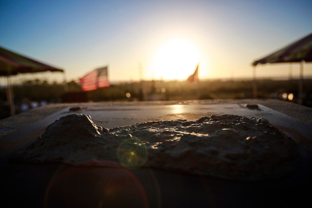 The sun sets over a commemorative statue of the island of Iwo Jima after the 71st anniversary memorial ceremony for the of the Battle of Iwo Jima, Feb. 20 at Camp Pendleton, Calif. During the 36-day battle for the 8.5 square-mile island, 6,821 Marines gave their lives to gain control of the strategic position in the Pacific during World War II. (U.S. Marine Corps photo by Lance Cpl. Caitlin Bevel)