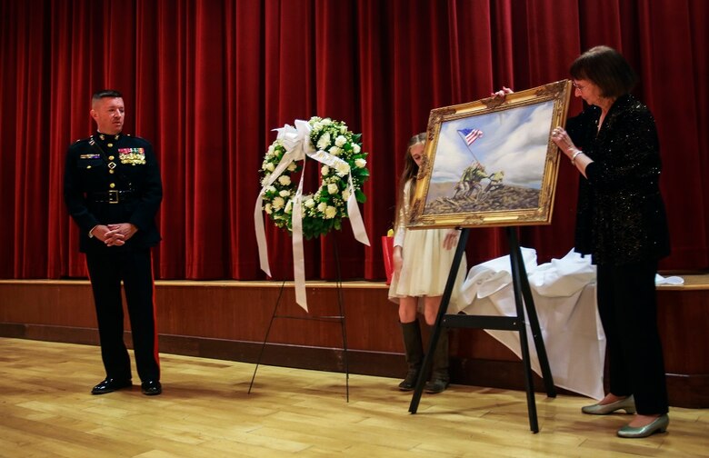 Brig. Gen. James Bierman, Jr., the guest speaker for the sunset memorial of the 71st anniversary of the Battle of Iwo Jima, Feb. 20 at Camp Pendleton, Calif., receives an original oil painting of the iconic flag raising on Mt. Suribachi. During the 36-day battle for the 8.5 square-mile island, 6,821 Marines gave their lives to gain control of the strategic position in the Pacific during World War II. Bierman, from Camp Lejeune, N.C., is the commanding general of the Western Recruiting Region and Marine Corps Recruit Depot San Diego. (U.S. Marine Corps photo by Lance Cpl. Caitlin Bevel)