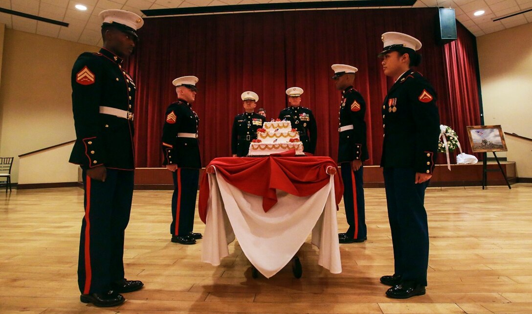 A detail of Marines presents a cake during the memorial dinner for the 71st anniversary of the Battle of Iwo Jima, Feb. 20 at Camp Pendleton. During the 36-day battle for the 8.5 square-mile island, 6,821 Marines gave their lives to gain control of the strategic position in the Pacific during World War II. The Marines in the cake detail are with Marine Corps Air Station Camp Pendleton. (U.S. Marine Corps photo by Lance Cpl. Caitlin Bevel)