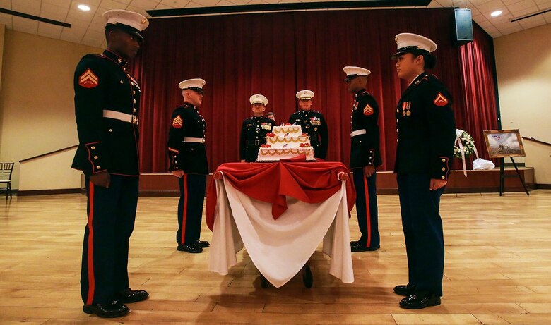 A detail of Marines presents a cake during the memorial dinner for the 71st anniversary of the Battle of Iwo Jima, Feb. 20 at Camp Pendleton. During the 36-day battle for the 8.5 square-mile island, 6,821 Marines gave their lives to gain control of the strategic position in the Pacific during World War II. The Marines in the cake detail are with Marine Corps Air Station Camp Pendleton. (U.S. Marine Corps photo by Lance Cpl. Caitlin Bevel)