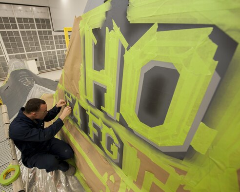 Senior Airman Paul Gatlin, an aircraft structural maintenance technician with the 49th Maintenance Squadron, finishes taping off the vertical stabilizer of the 54th Fighter Squadron’s F-16 Fighting Falcon flagship at Holloman Air Force Base, N.M., Nov. 10, 2015. Corrosion control specialists have the unique task of ensuring every aircraft on base is able to withstand deterioration caused by the weather. (U.S. Air Force photo/Airman 1st Class Randahl J. Jenson)